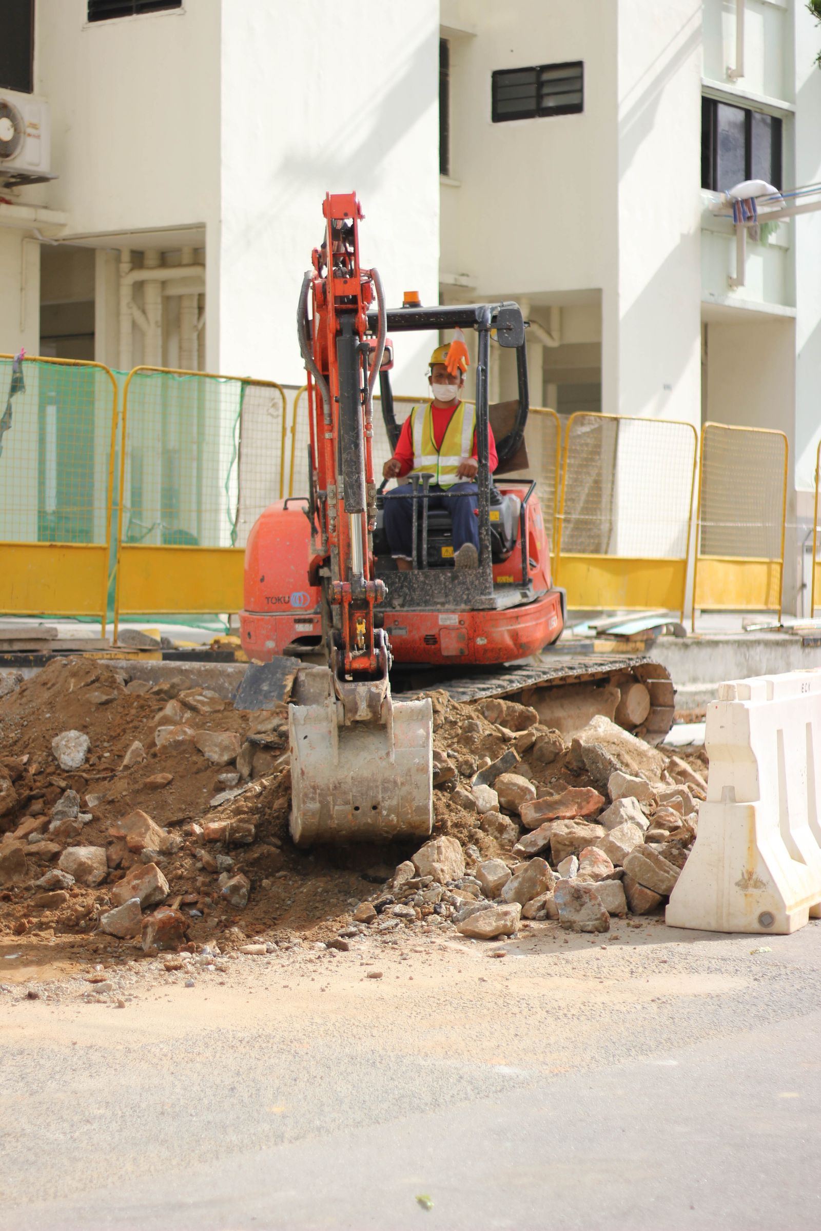 A mini excavator working on an urban site