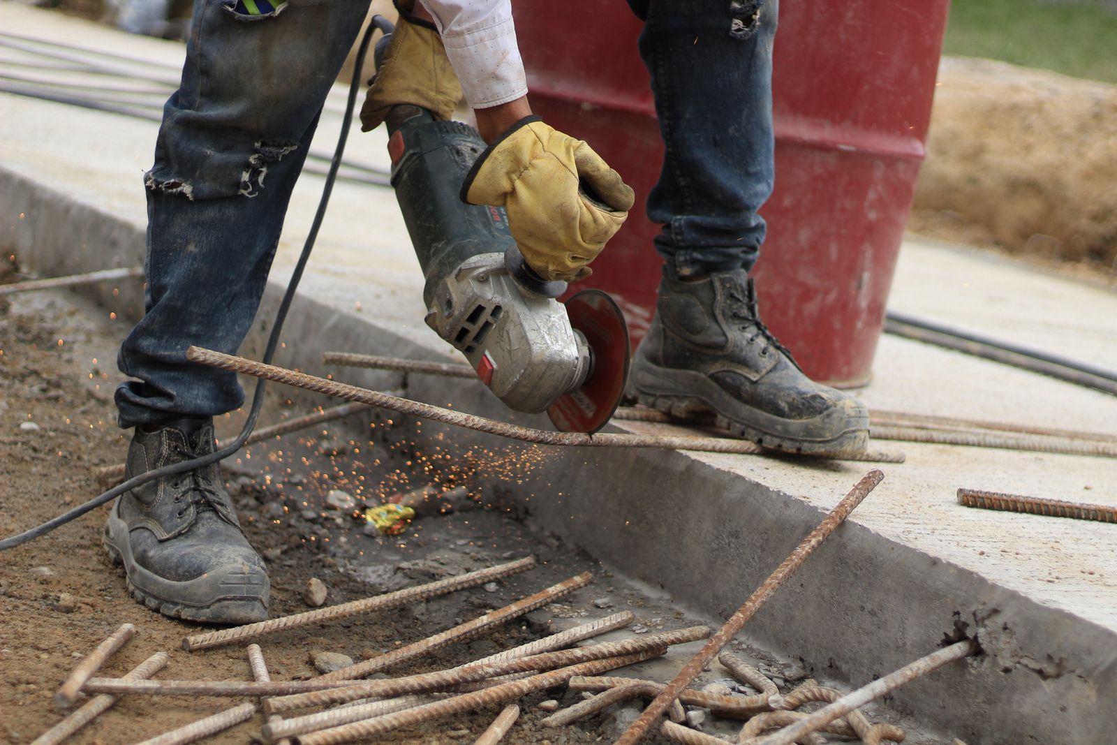 Close-up of steel-toe boots and gloves on a construction site