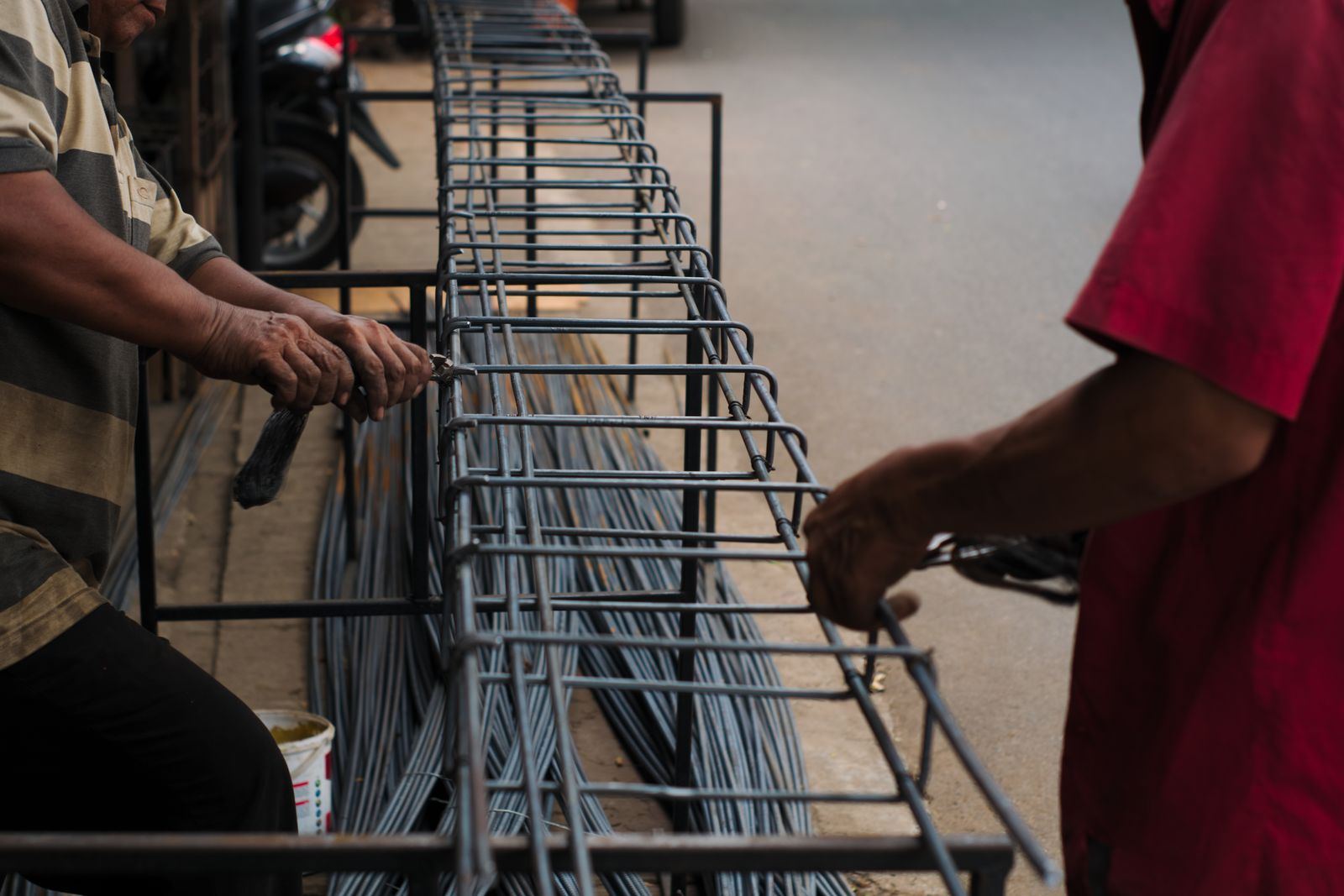 Hands tying steel reinforcement